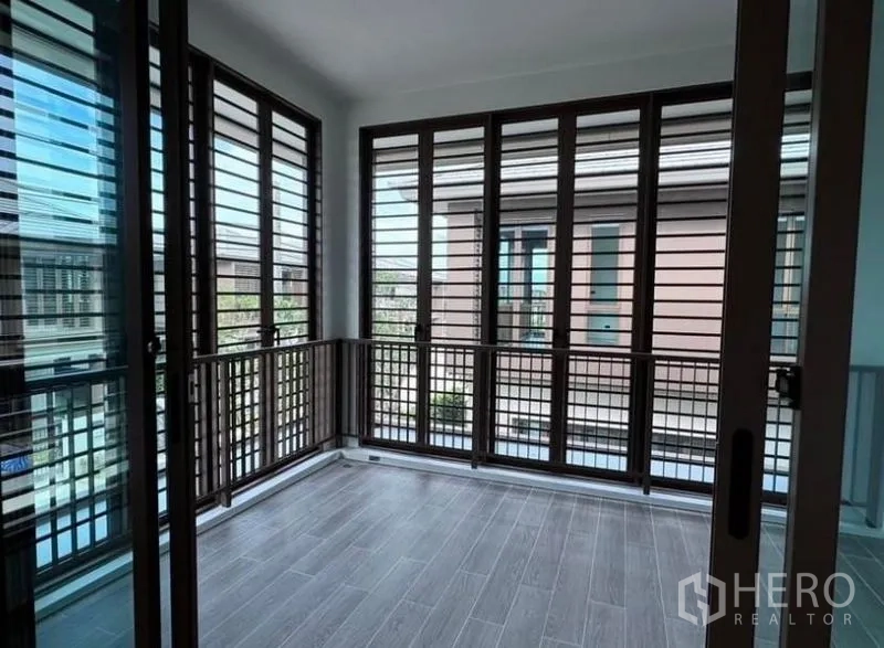 Detached House for rent in Bang Kapi, Bangkok - Enclosed balcony or sunroom with adjustable wooden louver screens.