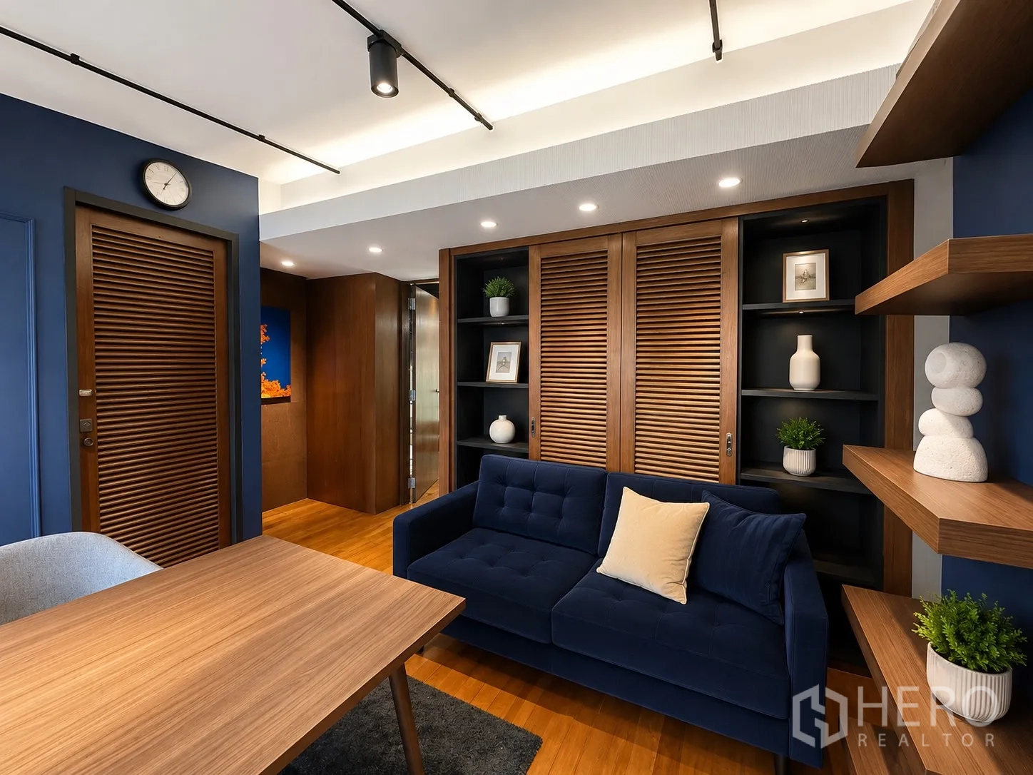 Office Space for rent in Phaya Thai, Bangkok - Cozy lounge area with navy sofa, wood shelving, and built-in cabinets.