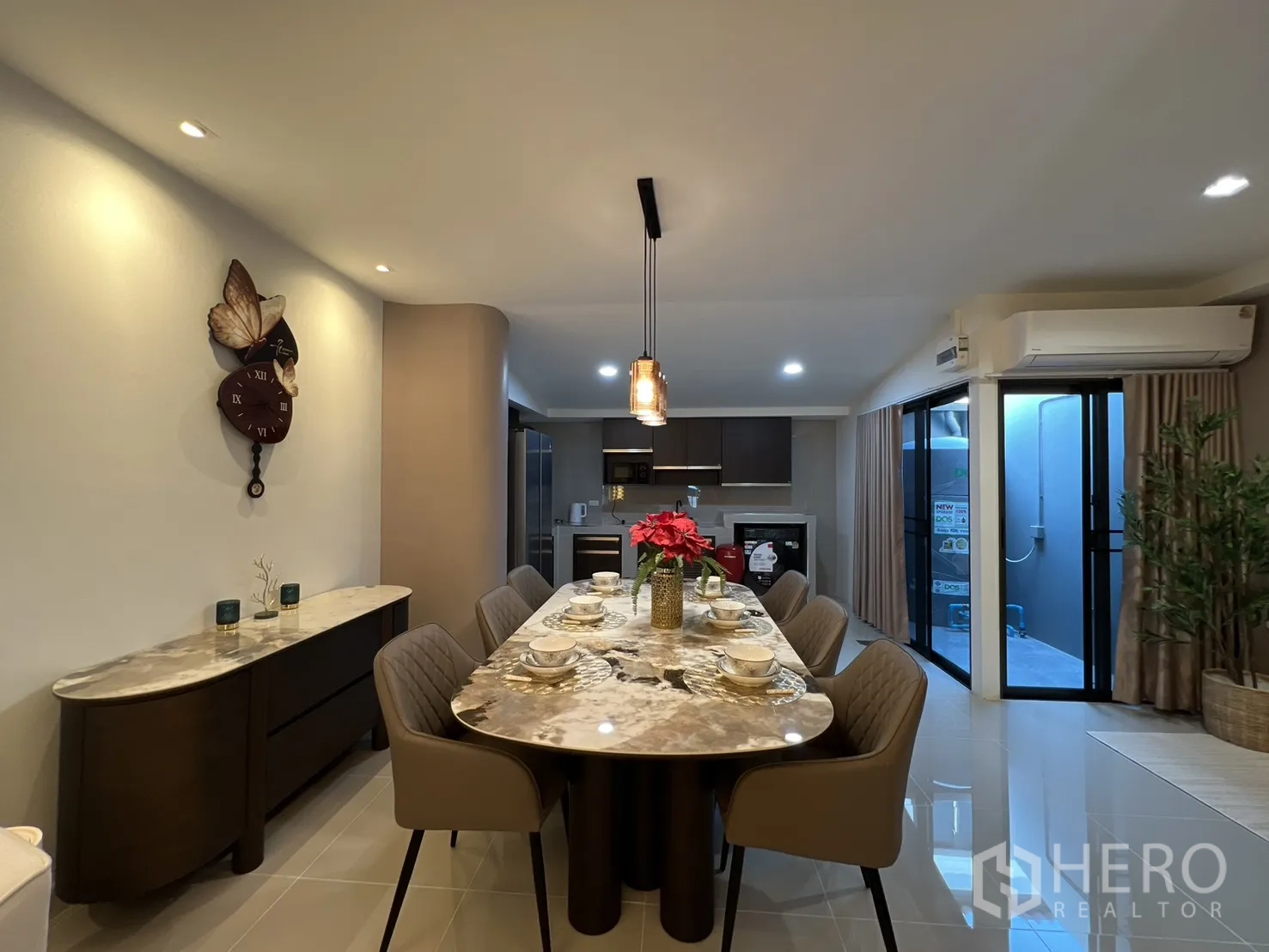 ทาวน์เฮาส์ for rent in Bang Phli, Samut Prakan - ห้องอาหารพร้อมโต๊ะหินอ่อนยาว นาฬิกาติดผนัง และประตูกระจกบานเลื่อนสองด้าน