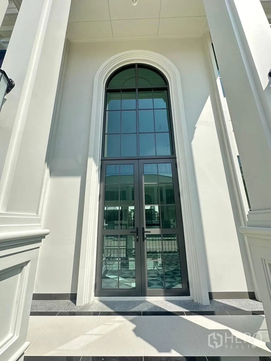 Detached House for rent in Bang Phli, Samut Prakan - Tall arched glass front door with white pillars and trim.