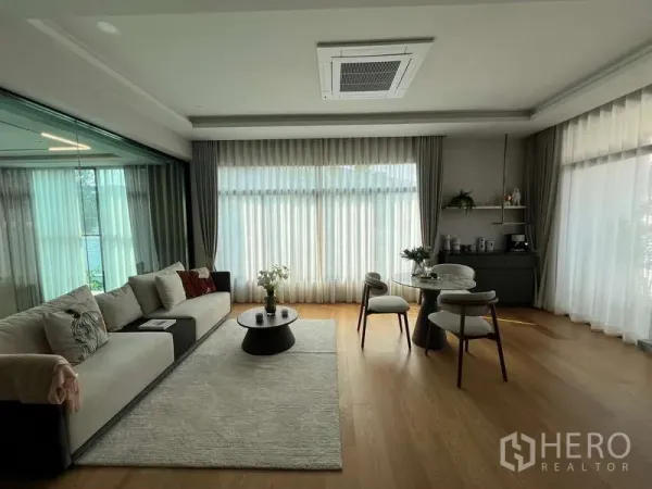 บ้าน ขายในSuan Luang, Bangkok - ห้องนั่งเล่นกว้าง พื้นไม้ ผ้าม่านโปร่ง และโซฟา