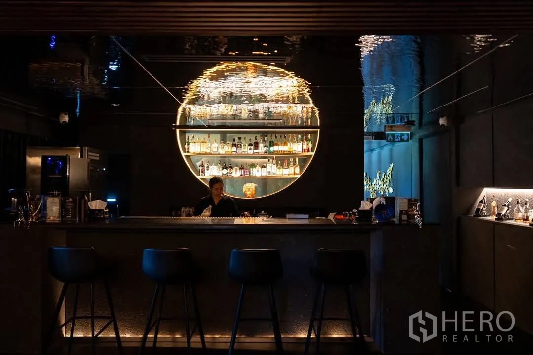 Retail Space for rent in Watthana, Bangkok - Contemporary bar counter with circular backlit shelving and moody lighting.