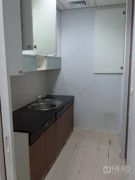 Office Space for rent in Bang Rak, Bangkok - Compact office pantry with sink, countertop and overhead cabinets.