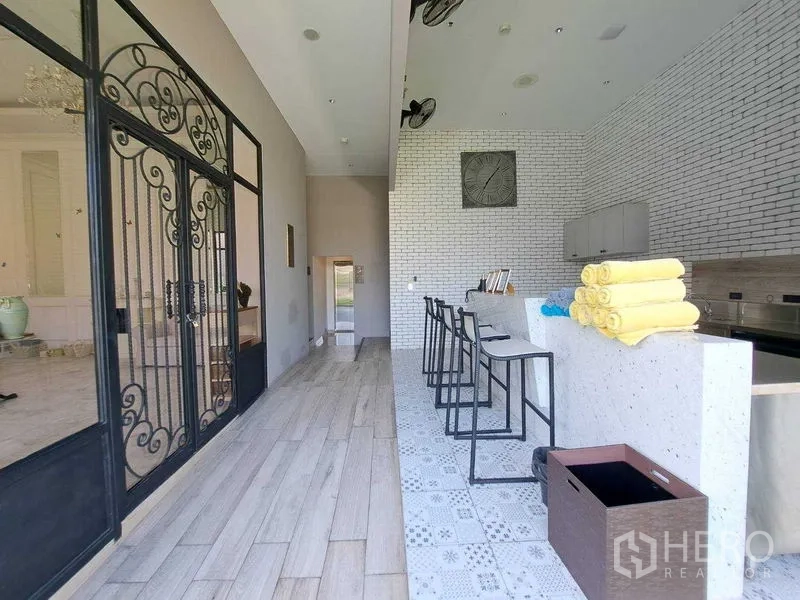 Retail Space for rent in Watthana, Bangkok - Bar counter with stools, wrought-iron doors and white brick accents.