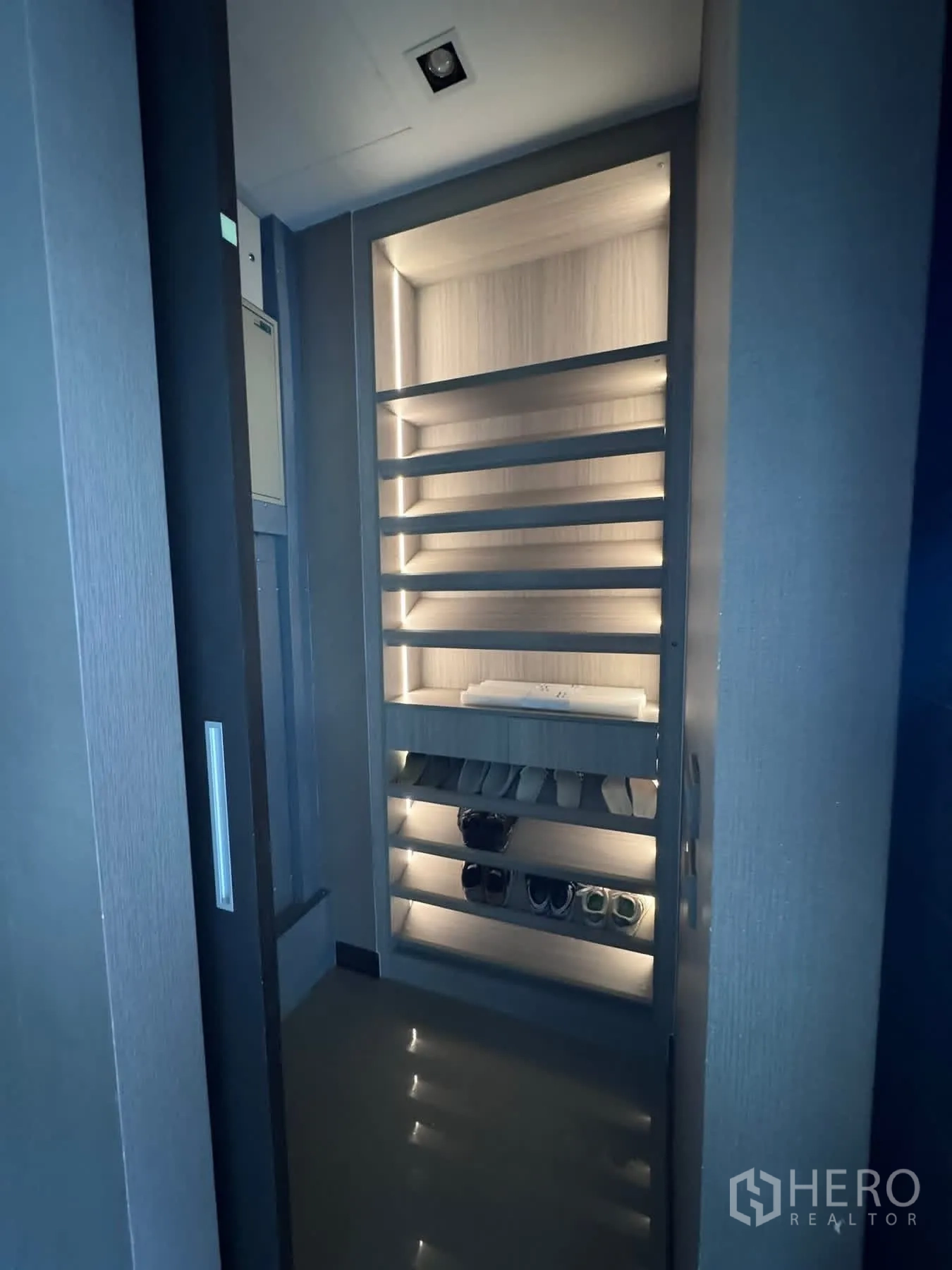 Townhouse for rent or sale in Lat Phrao, Bangkok - Shoe cabinet lit at night displaying organized footwear.
