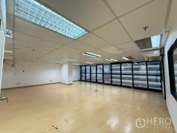Office Space for rent in Watthana, Bangkok - Bright corner workspace with floor-to-ceiling glass windows and city outlook.