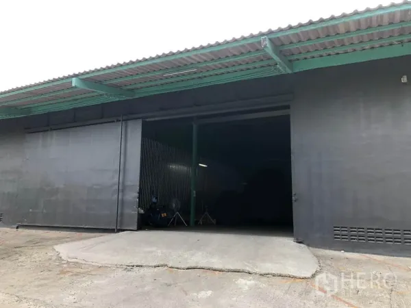 Warehouse for rent in Khan Na Yao, Bangkok - Loading ramp and large sliding entrance door under an extended canopy at the warehouse.