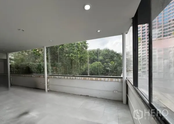 Retail Space for rent in Khlong Toei, Bangkok - Bright upper floor interior with floor-to-ceiling glass and leafy green views.