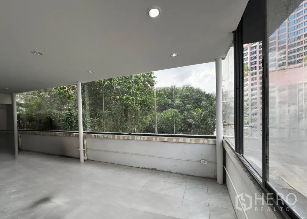 Retail Space for rent in Khlong Toei, Bangkok - Bright upper floor interior with floor-to-ceiling glass and leafy green views.