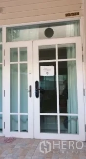 Townhouse for rent or sale in Chatuchak, Bangkok - Front entry featuring white French doors with glass panes and a transom window.