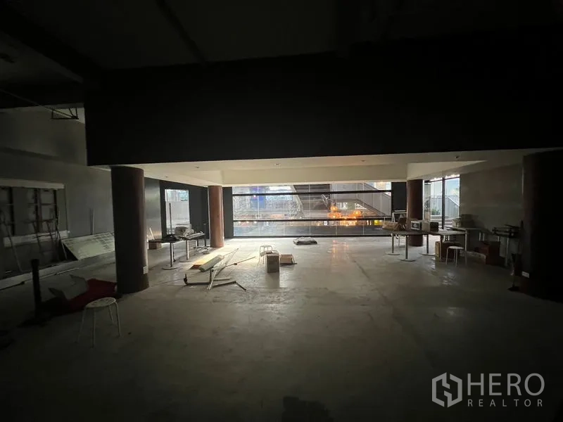 Retail Space for rent in Watthana, Bangkok - Large retail hall with natural light from full-height windows overlooking an urban walkway.