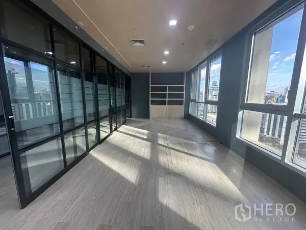 办公空间 出租在Bang Rak, Bangkok - 转角独立办公室，内置书架，透过高窗可观城市景观。