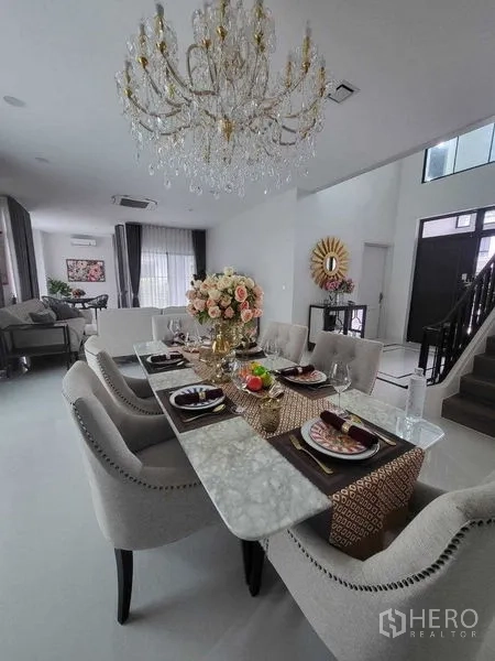 Detached House for rent in Saphan Sung, Bangkok - Dining area with marble table and crystal chandelier set for six.