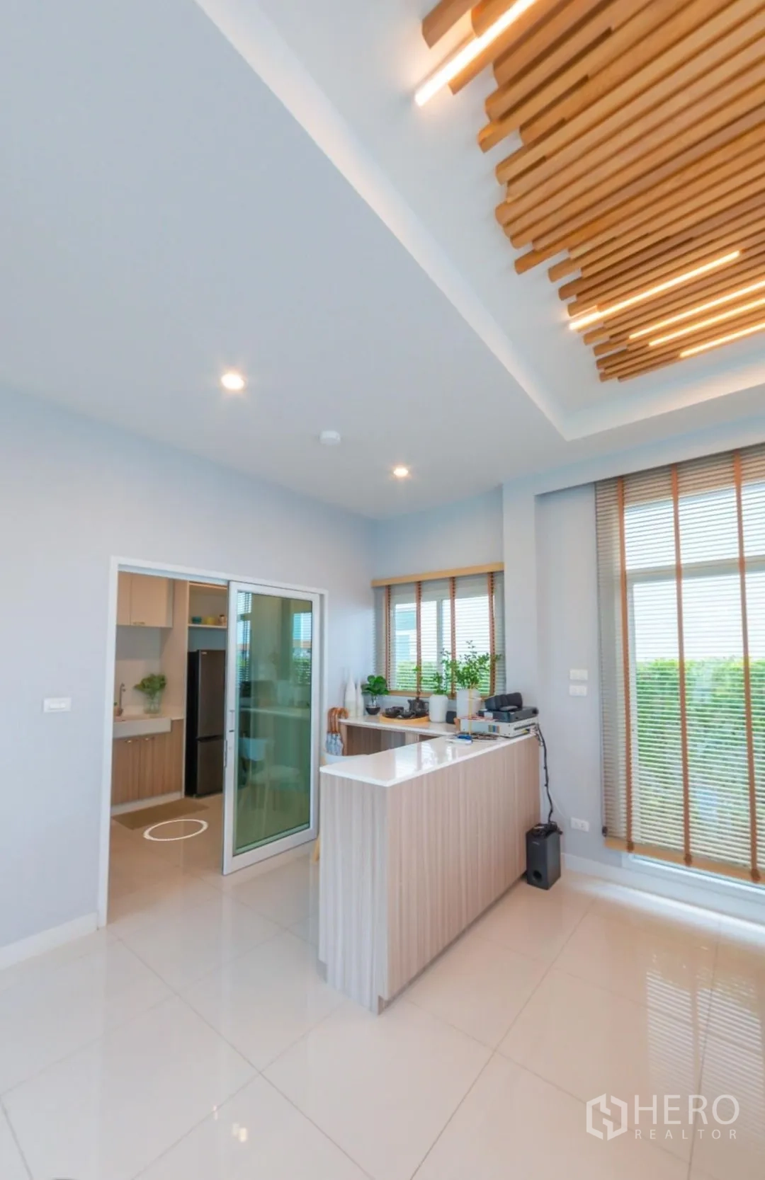 Detached House for rent in Lam Luk Ka, Pathum Thani - Open dining area with breakfast counter, sliding door to kitchen, and feature ceiling lights.