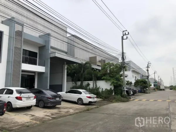 Factory for rent or sale in Bang Phli, Samut Prakan - Modern factory units in a secure Bang Phli industrial compound with on-street parking and power lines.