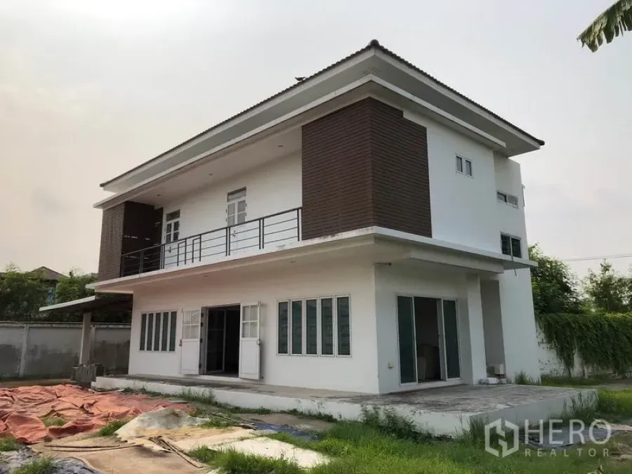 บ้าน ขายในBang Khen, Bangkok - บ้านเดี่ยวสองชั้นสไตล์โมเดิร์น ภายนอกมีระเบียง กรุลายไม้ หน้าต่างบานใหญ่ และลานบ้านในรั้วรอบขอบชิด
