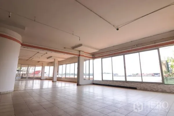Retail Space for rent in Yan Nawa, Bangkok - Spacious open-plan retail interior with floor-to-ceiling windows, tiled flooring, and abundant natural light overlooking the city.