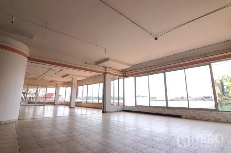 Retail Space for rent in Yan Nawa, Bangkok - Spacious open-plan retail interior with floor-to-ceiling windows, tiled flooring, and abundant natural light overlooking the city.
