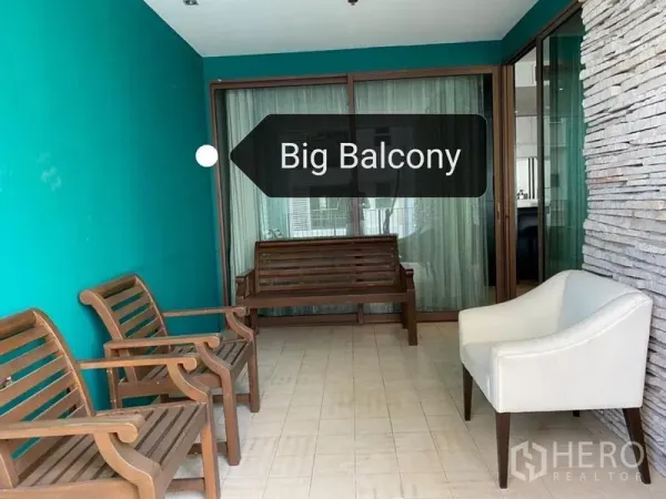Condominium for rent - Spacious covered balcony with seating, teal accent wall and sliding glass doors