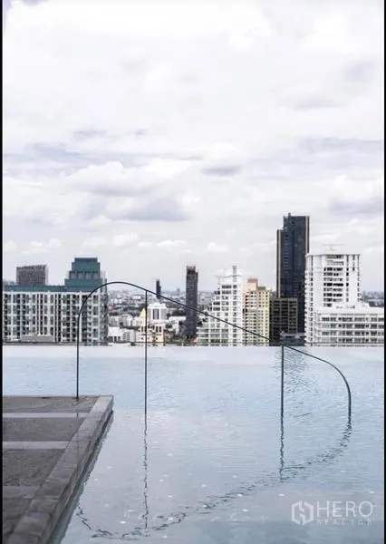 Condominium for rent or sale in Watthana, Bangkok - Infinity pool edge with handrail and panoramic city view.