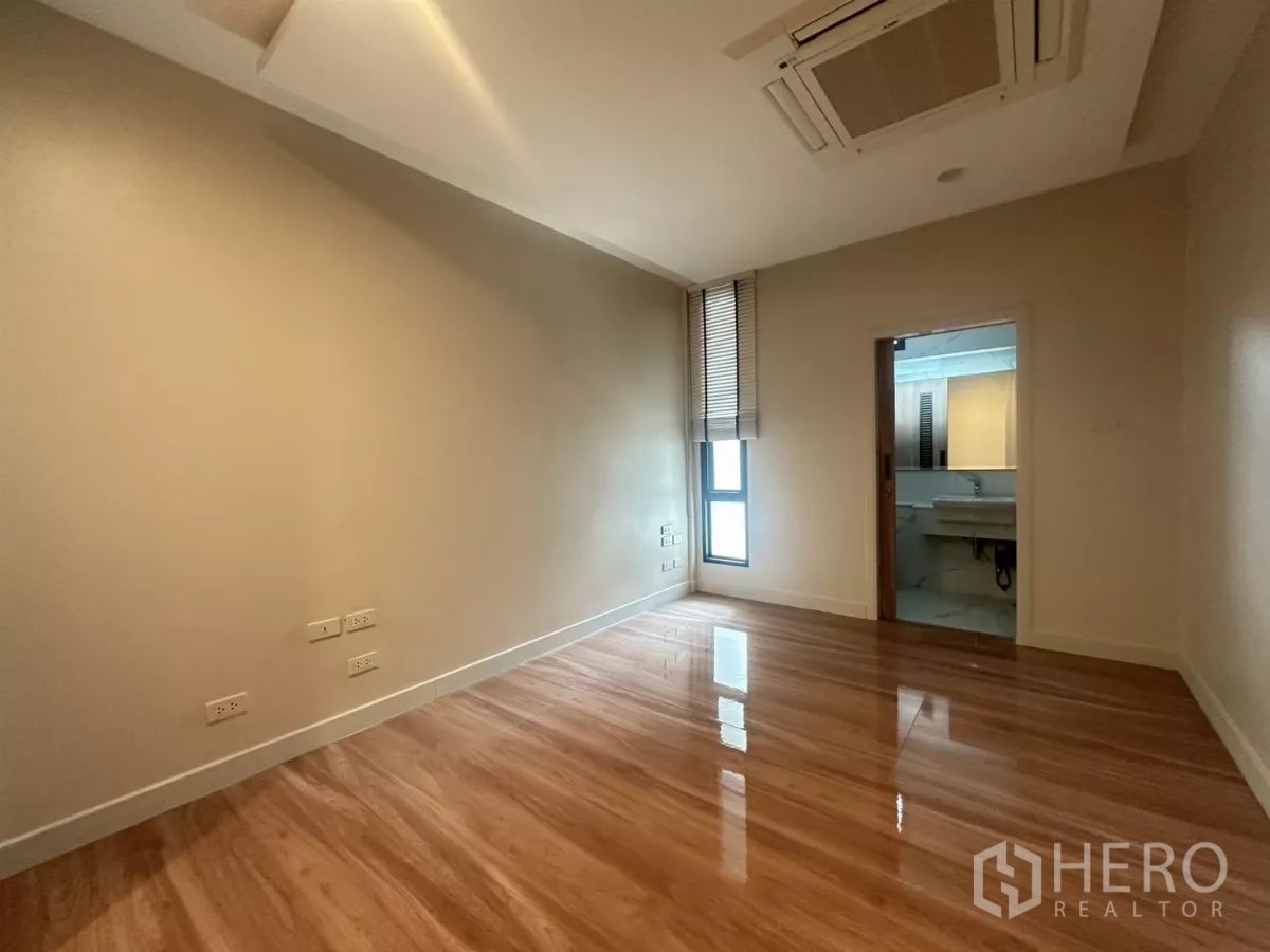 联排别墅 出租在Watthana, Bangkok - 套间卧室，木地板、百叶窗与嵌灯。
