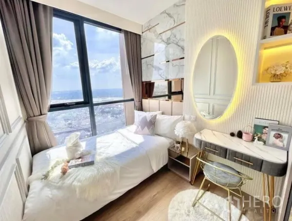 Condominium for rent in Khlong Toei, Bangkok - Sunlit bedroom with floor-to-ceiling window, marble accent wall, built-in vanity and expansive city view.