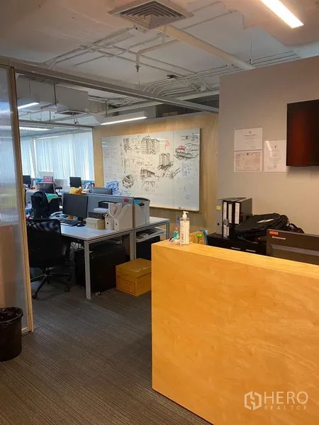 Office Space for rent in Khlong Toei, Bangkok - Reception desk facing open-plan workstations and a large whiteboard wall.