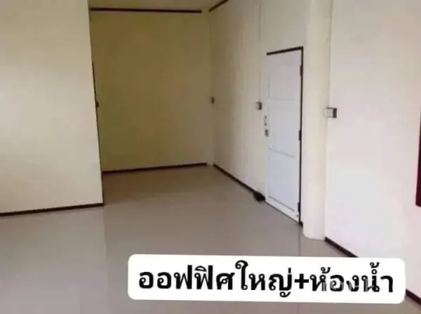 Warehouse for rent in Nakhon Pathom - Clean office room inside the warehouse with tiled floor, light walls and an adjoining restroom door.