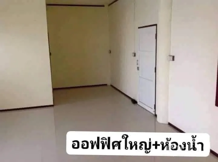 Warehouse for rent in Nakhon Pathom - Clean office room inside the warehouse with tiled floor, light walls and an adjoining restroom door.