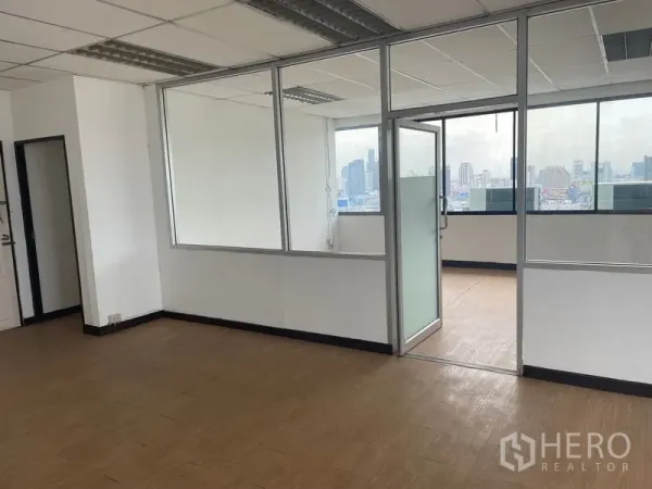Office Space for rent in Din Daeng, Bangkok - Bright Bangkok office interior with glass-partitioned room, wood-look flooring, and large windows showing skyline views in Din Daeng.