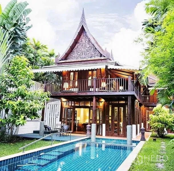 Detached House for rent in Bang Na, Bangkok - Exterior of Thai teak detached house with ornate gable roof and private swimming pool.