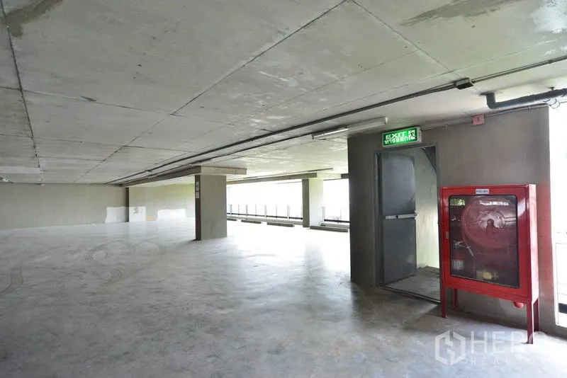 办公空间 出租在Phaya Thai, Bangkok - 宽敞的室内停车或服务楼层，配有消防水带柜与紧急出口。