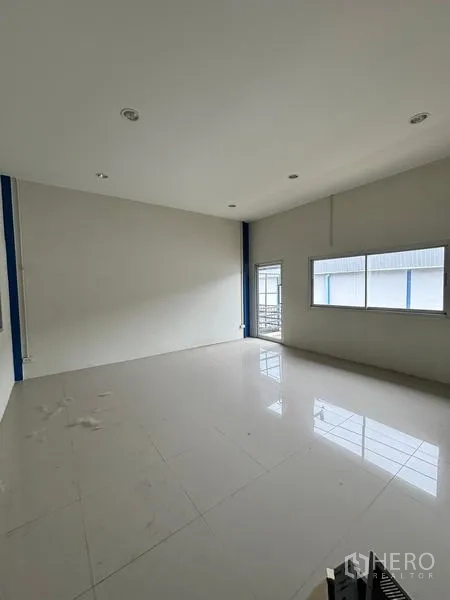 Warehouse for rent in Krathum Baen, Samut Sakhon - Bright upstairs office with large window and door to a small balcony.