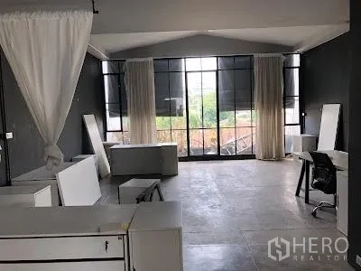 带办公室的家 出租在Watthana, Bangkok - 采光充足的办公区，大面积黑框窗、窗帘与分散的办公桌。