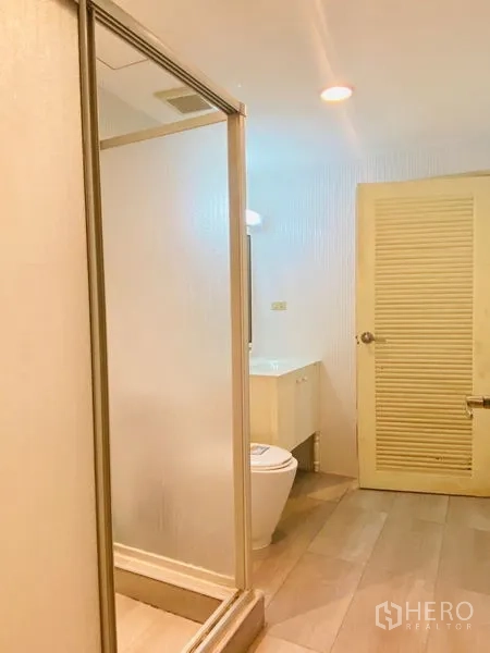 คอนโด ให้เช่าในWatthana, Bangkok - ห้องน้ำพร้อมตู้ shower กระจก สุขภัณฑ์ และพื้นกระเบื้องโทนอ่อนข้างประตูบานเกล็ด