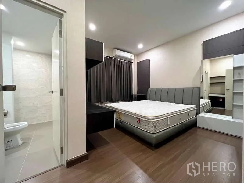 独立式住宅 出售在Prawet, Bangkok - 客卧配软包床架，直通套卫，内置柜体与深色窗帘。