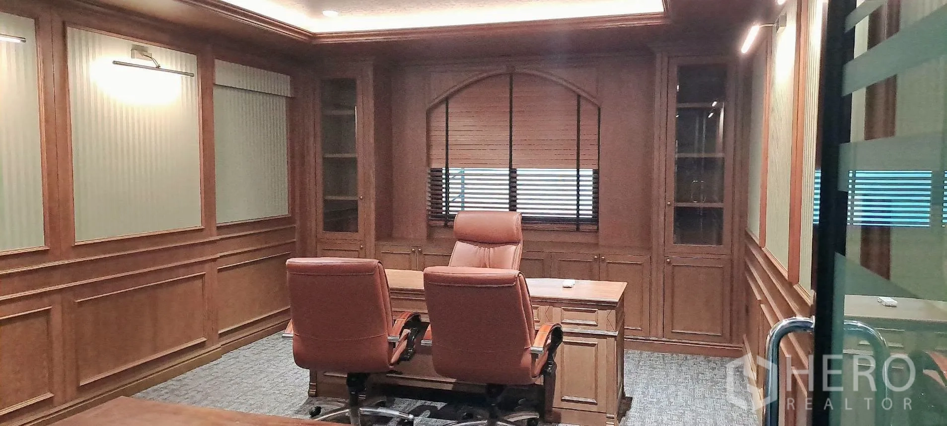 Home Office for rent in Lat Phrao, Bangkok - Executive office with classic wood paneling, built-ins and leather chairs.