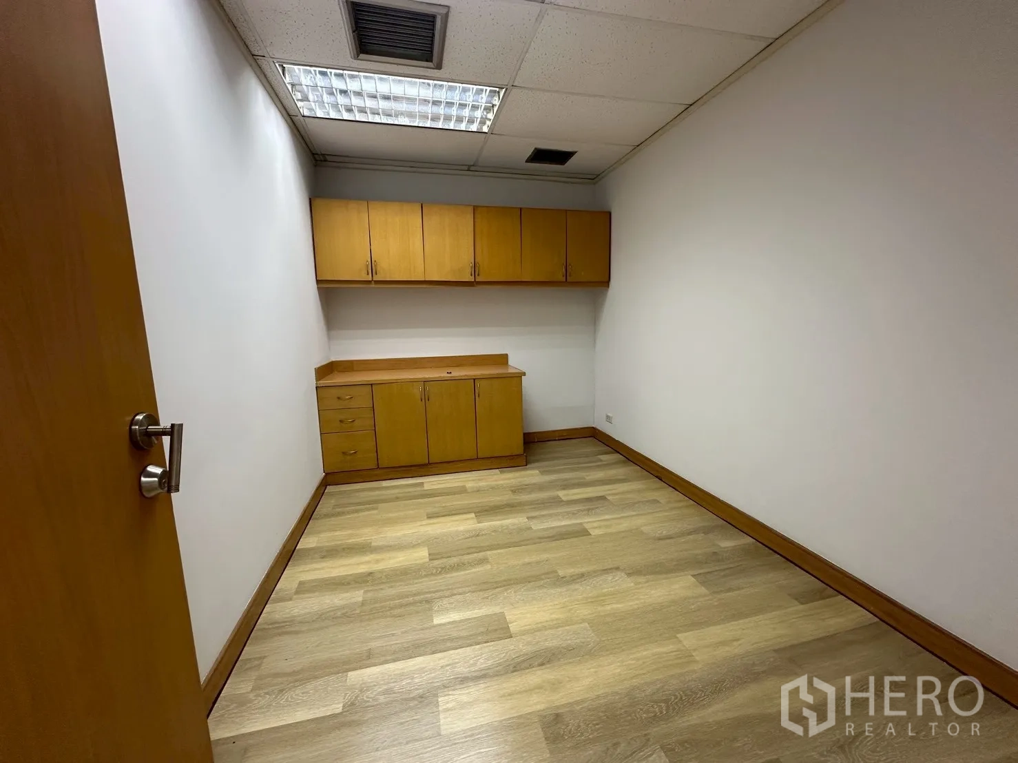 Office Space for rent - Built-in dry pantry with overhead cabinets and wood counters inside the office.