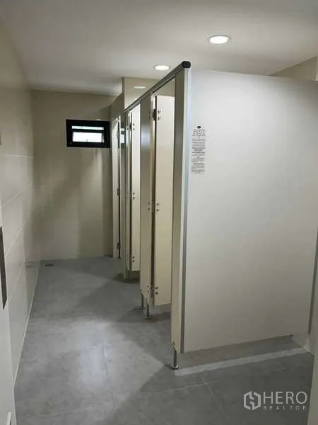 Office Space for rent in Bang Rak, Bangkok - Row of clean toilet stalls inside shared restroom.