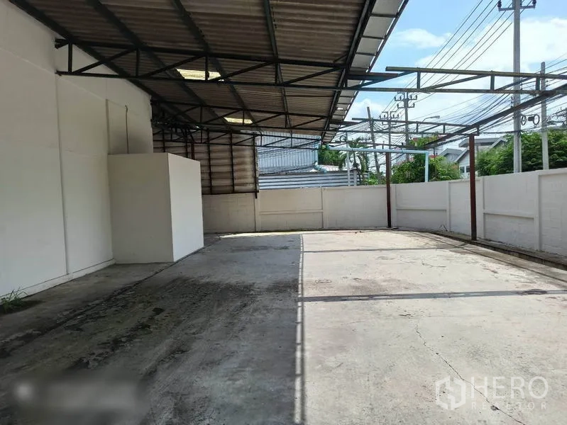 工厂 出租在Min Buri, Bangkok - 后方有顶院落，混凝土地坪与围墙。