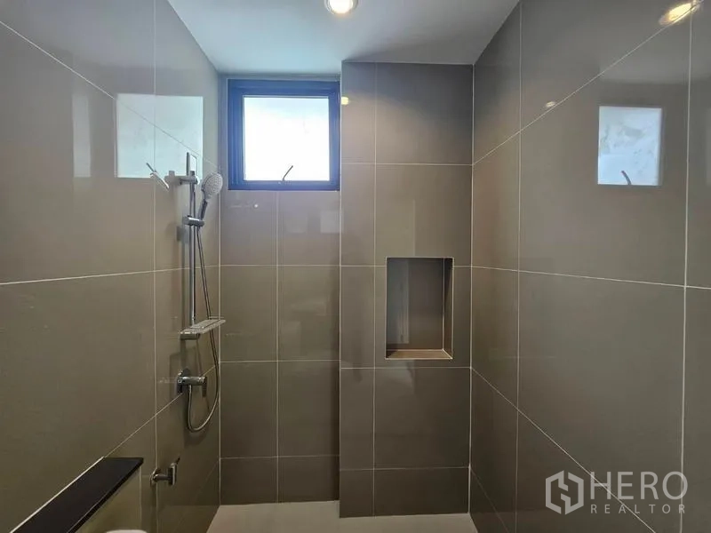 Detached House for rent in Saphan Sung, Bangkok - Tiled walk-in shower with recessed shelf and small window for ventilation.