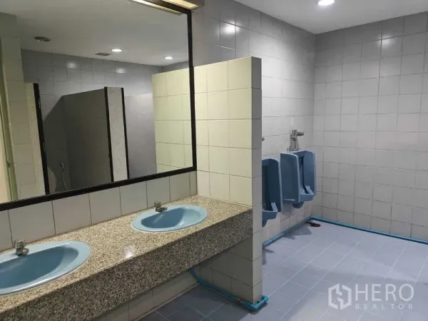 Office Space for rent in Din Daeng, Bangkok - Men’s restroom with twin blue sinks, a large mirror, and urinals.