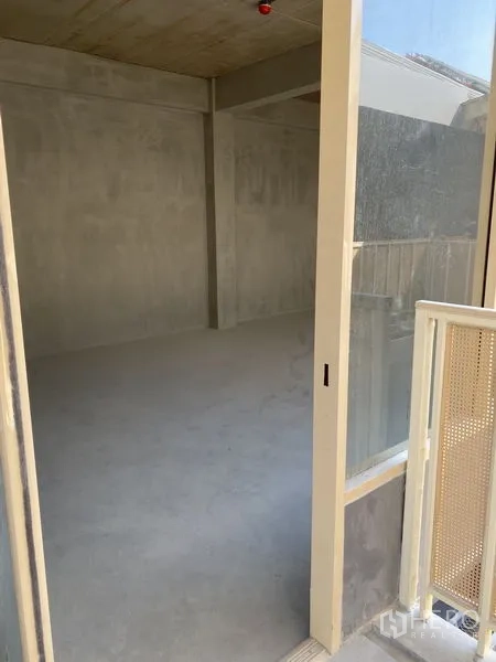 Retail Space for rent in Watthana, Bangkok - Glass sliding door opening to an unfinished concrete retail unit with natural light.