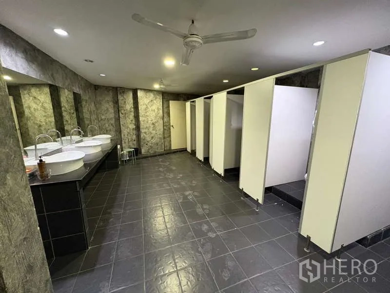 Standalone for rent in Khlong Toei, Bangkok - Large bathroom with multiple sinks and toilet stalls.