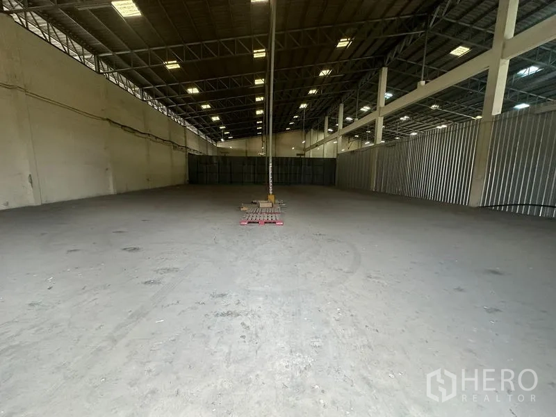 Warehouse for rent in Yan Nawa, Bangkok - Large unobstructed warehouse bay with grid lighting and a central column.