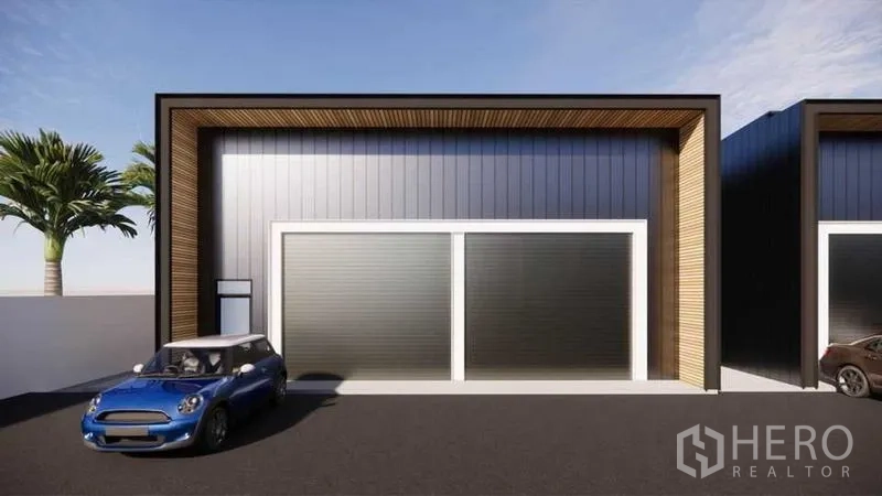 Warehouse for rent - Front elevation of warehouse unit with two roller shutter doors and a wide driveway for parking.