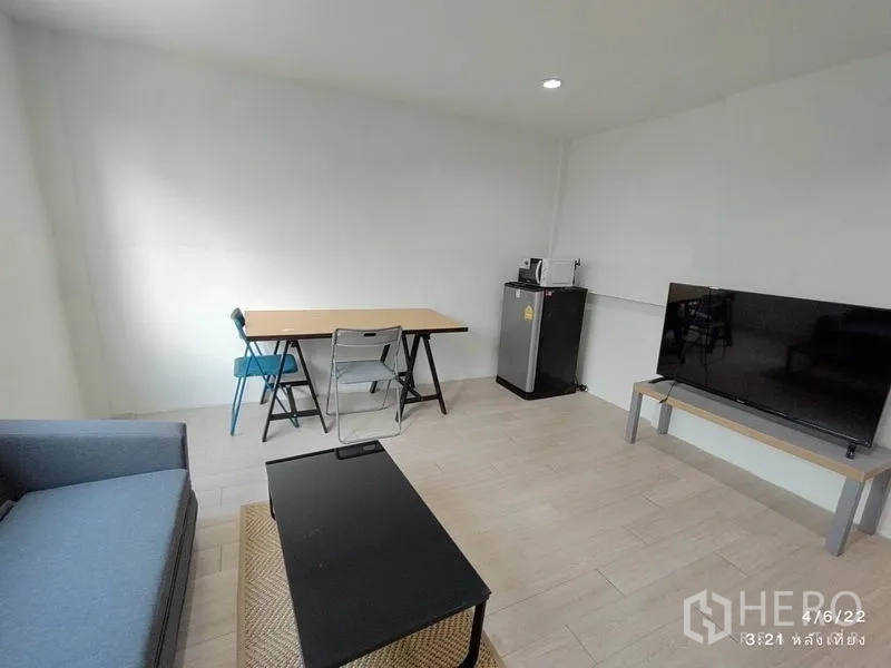 Home Office for rent - Work corner with study desk and chairs, compact fridge, microwave and flat-screen TV.