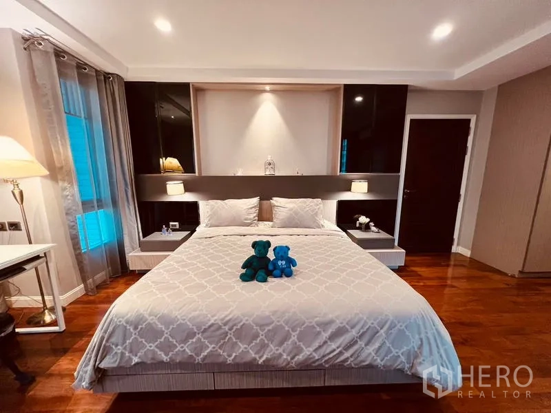带办公室的家 出租在Khlong Toei, Bangkok - 主卧特大床，设计感床头、床头灯与柔和窗帘。