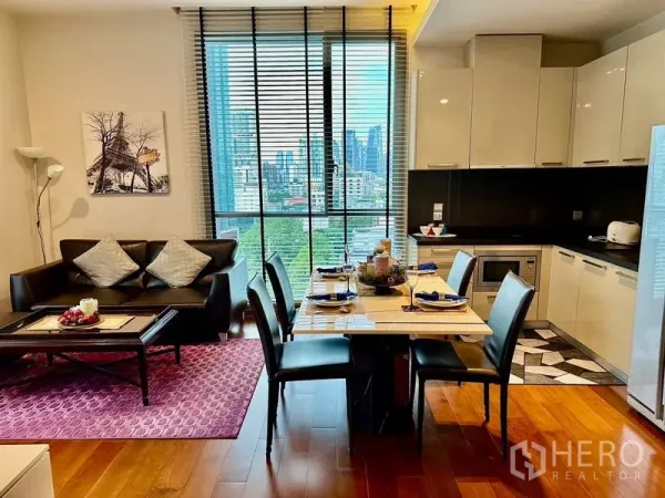 Condominium for rent in Watthana, Bangkok - Open-plan living–dining and glossy kitchen facing city views.
