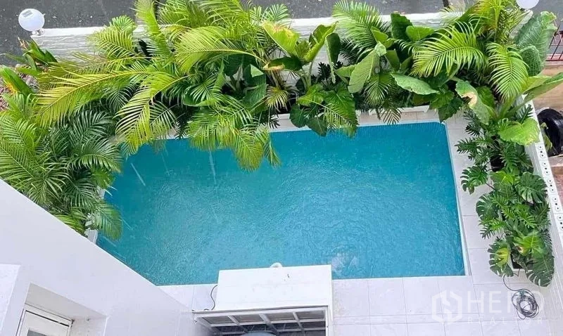 Townhouse for sale - Private swimming pool bordered by lush tropical plants for added privacy.